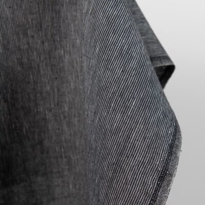 Heavy linen fabric in black and white stripes edge view