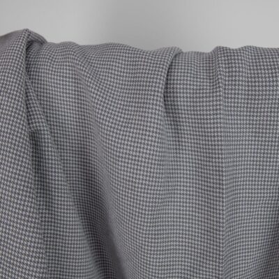 Washed linen cotton fabric grey houndstooth pattern close up detail