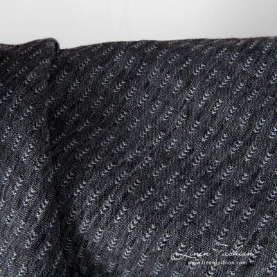 Closer view of black and grey tick pattern linen fabric, washed