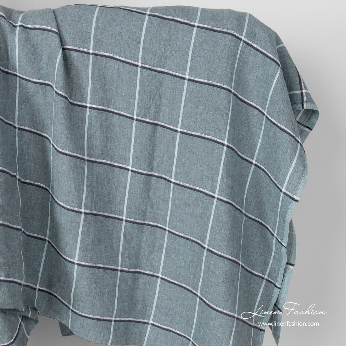Washed green grid check linen fabric.