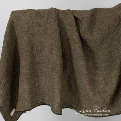 Linen fabric in moss green, washed.