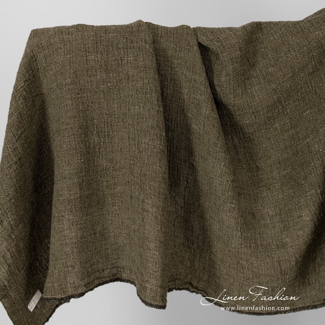 Linen fabric in moss green, washed.