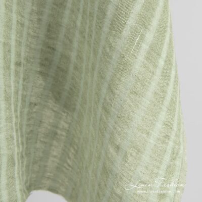 Green linen fabric in transparent vertical stripes