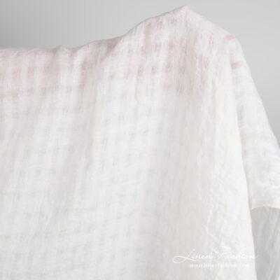 Off-white linen fabric in transparent checks, specially washed to increase softness
