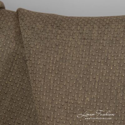 Brown dyed linen fabric with spots.