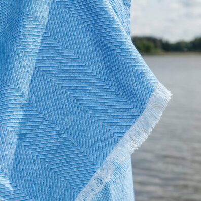 Light blue herringbone linen cotton beach towel, with fringe