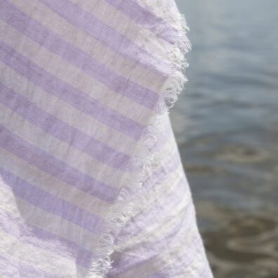Linen beach towel in yellow and lilac stripes, with fringe
