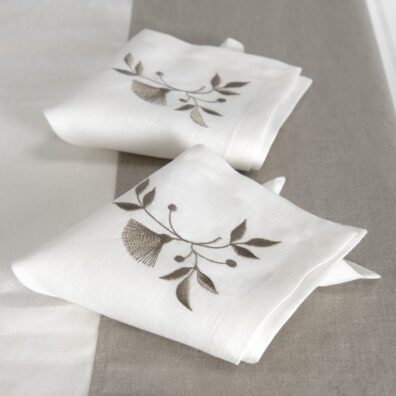 Off-white napkin with brownish floral stitching, 100% linen