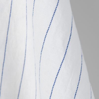 Washed linen cotton fabric white with blue stripes. Stonewashed